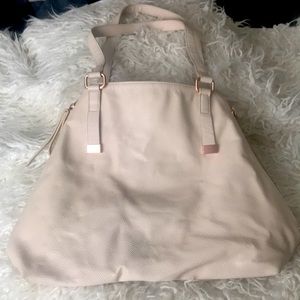 Banana republic purse. Rose gold Zippers on sides to make closure smaller.